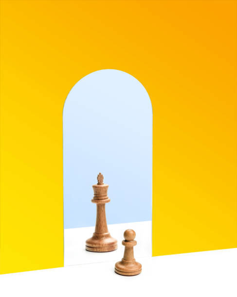 Chess pawn in front of the reflection of the chess queen in the mirror. Self esteem concept.