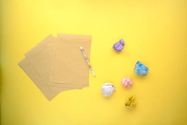 crumpled paper ball and notepad on wooden table for Stress Journal