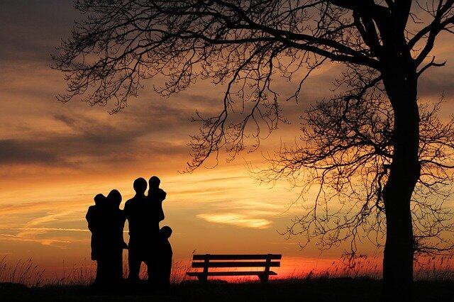 Family in front of sunset representing family goals