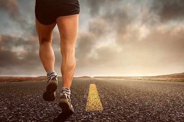 Man on road with shoes representing exercise