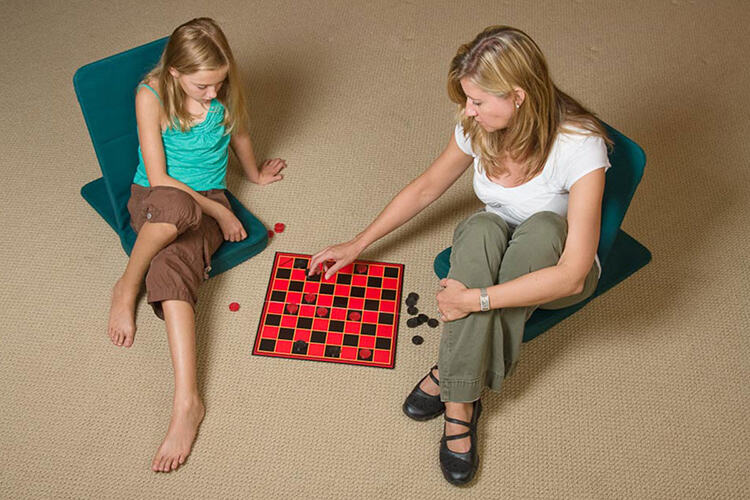 Woman and kid sitting on Black Jack chair playing