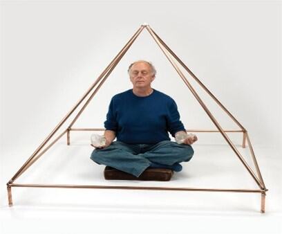 Man Meditating under the meditation pyramid