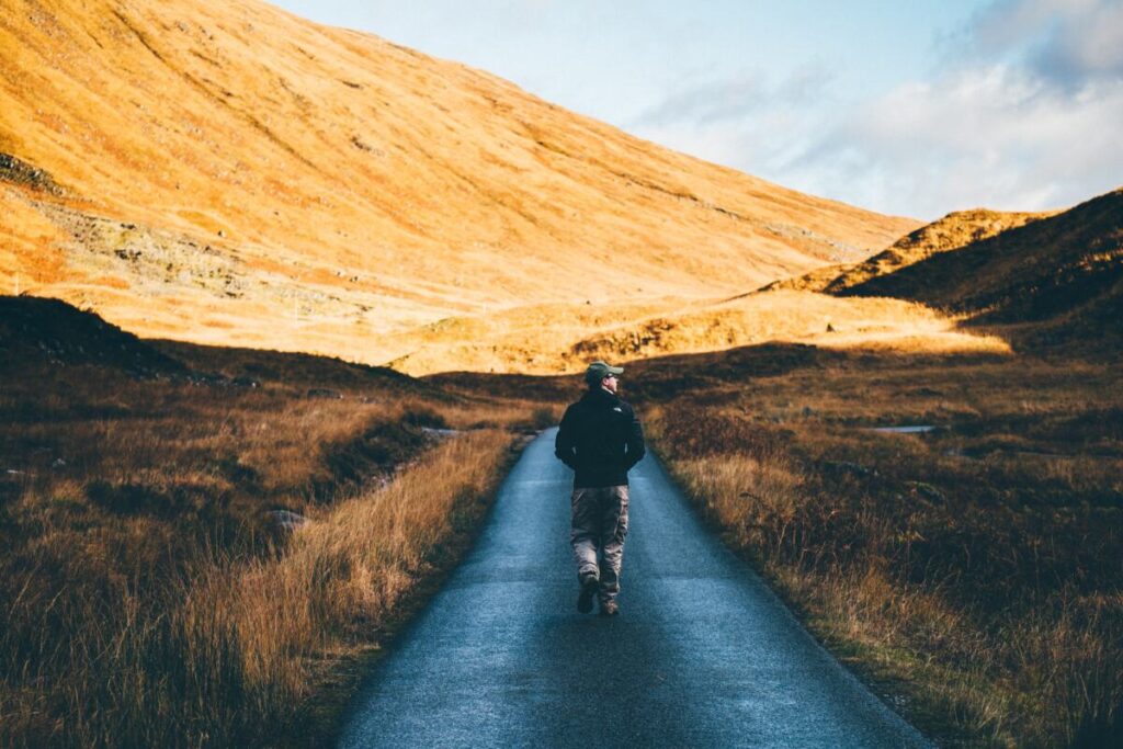 Man on road walking away