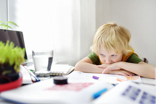 Kid looking at his homework books