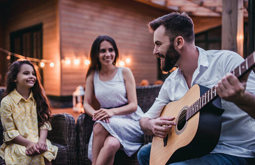 Happy family is sitting on house's terrace and smiling - Kids out on a date