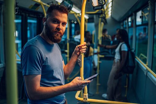 Man smiling in the bus - Sing To Strangers On The Subway