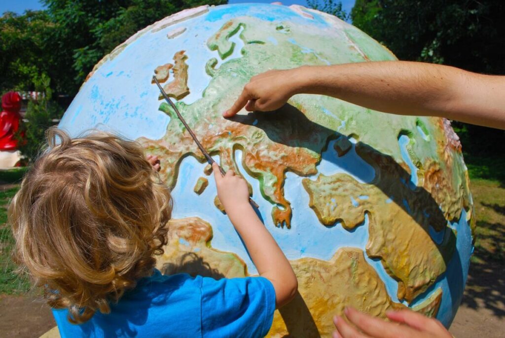 Kid pointing fingers on the globe - Long Term Goals for Middle School Students