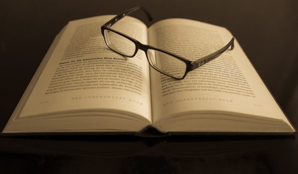 Book with glasses open - Acquire Knowledge