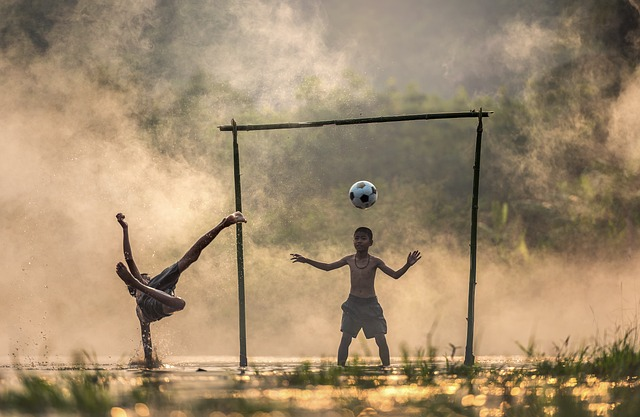 children playing football representing goal