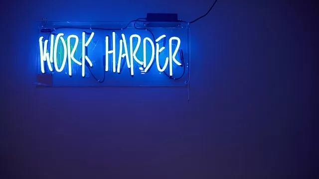 text in neon saying work harder