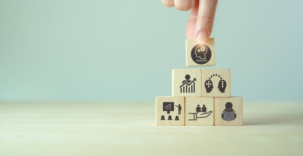 man stacking blocks on top of each other representing personal development.