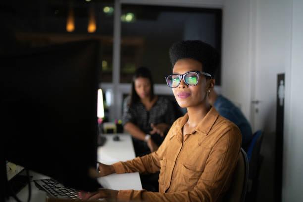 Portrait of businesswoman working late in the office Portrait of businesswoman working late in the office smart goals stock pictures, royalty-free photos & images