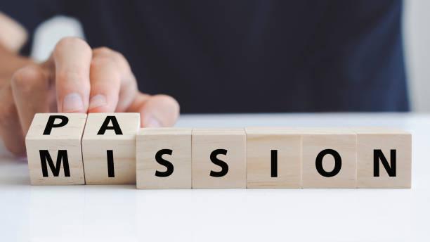 Hand of a man who turning a wooden block with the word passion and mission. Hand turns wooden block and changes the name "mission" to "passion". Hand of a man who turning a wooden block with the word passion and mission. Hand turns wooden block and changes the name "mission" to "passion". goals and resolutiomns stock pictures, royalty-free photos & images