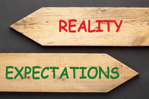 Reality Expectations Concept The words Reality vs. Expectations written on old wooden arrows on black background. mistakes in goal setting stock pictures, royalty-free photos & images